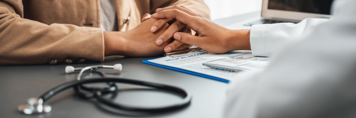 Doctor show medical diagnosis report and providing compassionate healthcare consultation while holding young patient hand for being supportive and professional in doctor clinic office. Neoteric